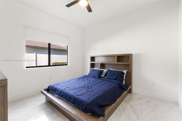 bedroom featuring marble finish floor, ceiling fan, and baseboards