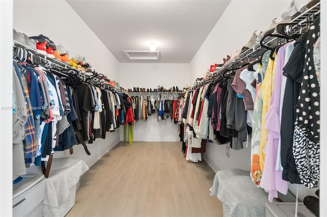 spacious closet featuring attic access and wood finished floors