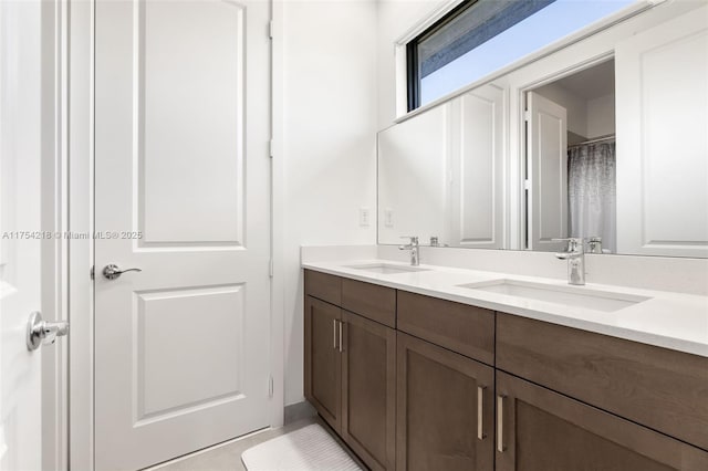 bathroom featuring double vanity and a sink