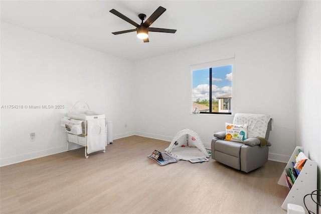 game room with wood finished floors, a ceiling fan, and baseboards