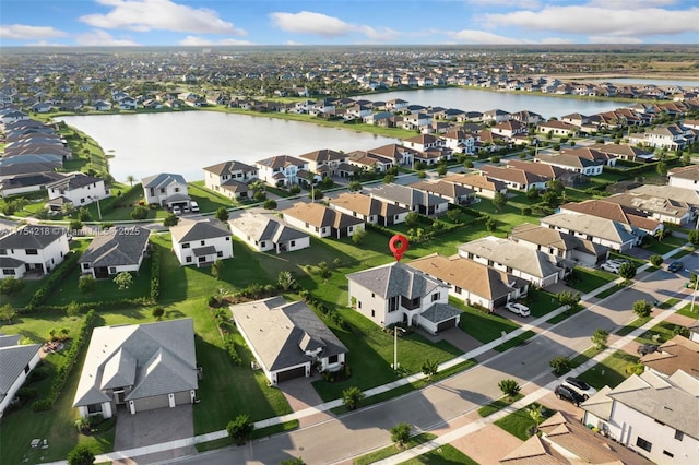 bird's eye view with a water view and a residential view