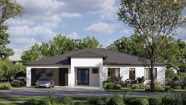 view of property with a garage and concrete driveway