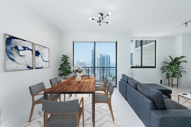 dining area featuring a city view and a notable chandelier