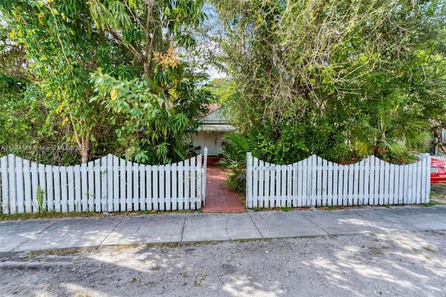 view of gate featuring a fenced front yard