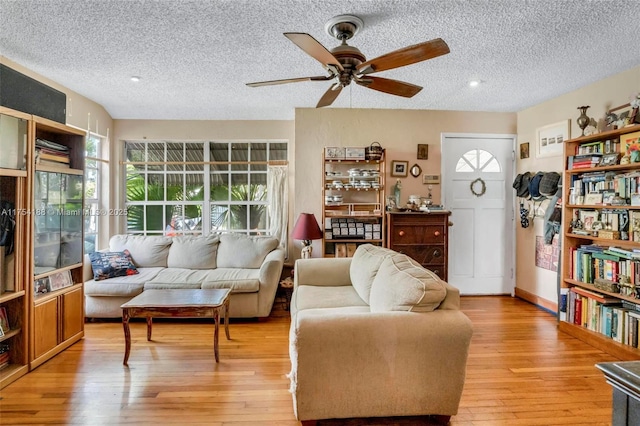 interior space with a textured ceiling, light wood finished floors, and a ceiling fan