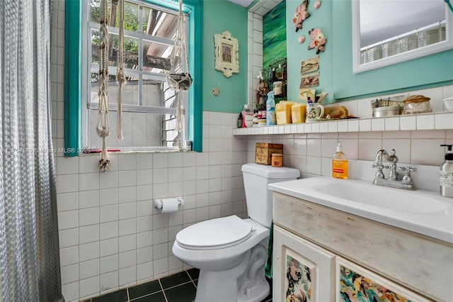 full bath with toilet, plenty of natural light, tile walls, and tile patterned flooring