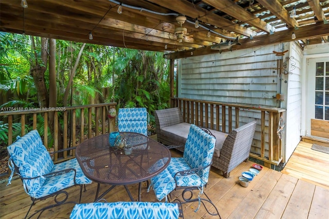 deck featuring outdoor dining space and a pergola