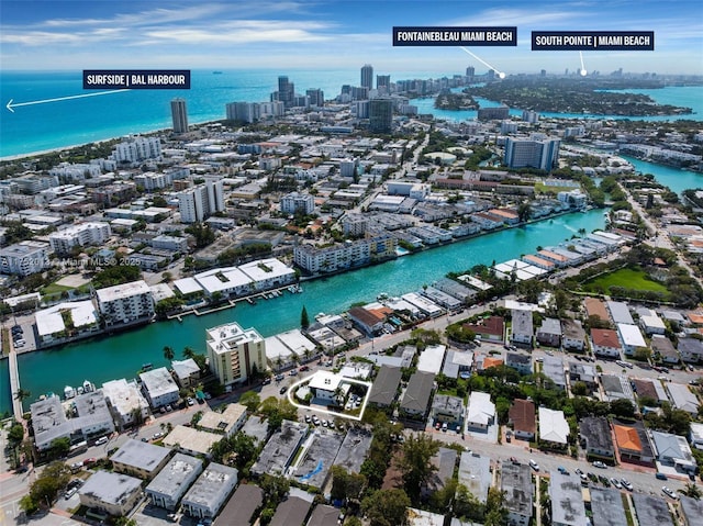 birds eye view of property featuring a view of city and a water view