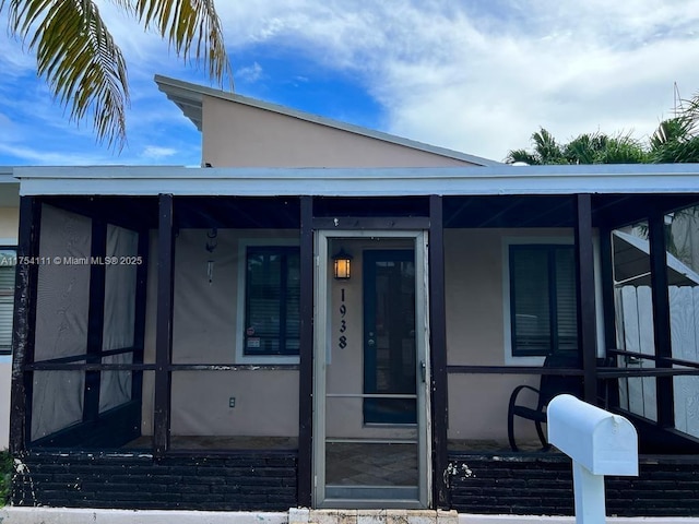 doorway to property with stucco siding