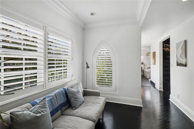 interior space featuring baseboards, ornamental molding, and wood finished floors