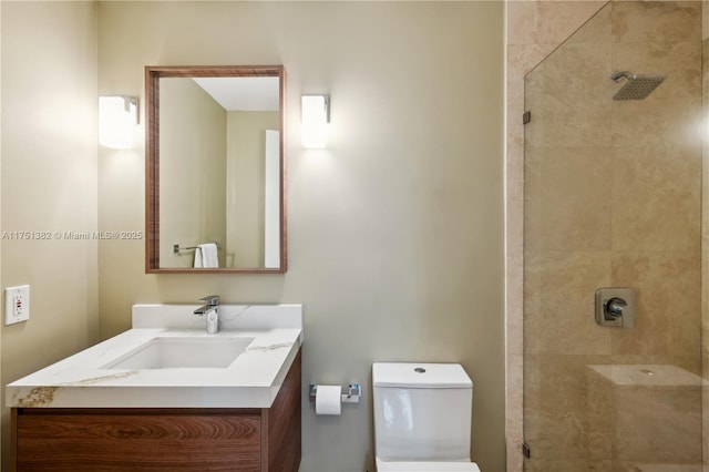 full bath with tiled shower, vanity, and toilet