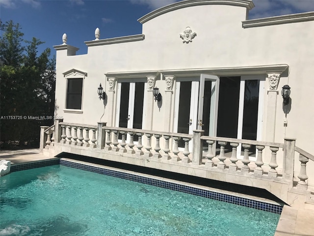 back of house with stucco siding