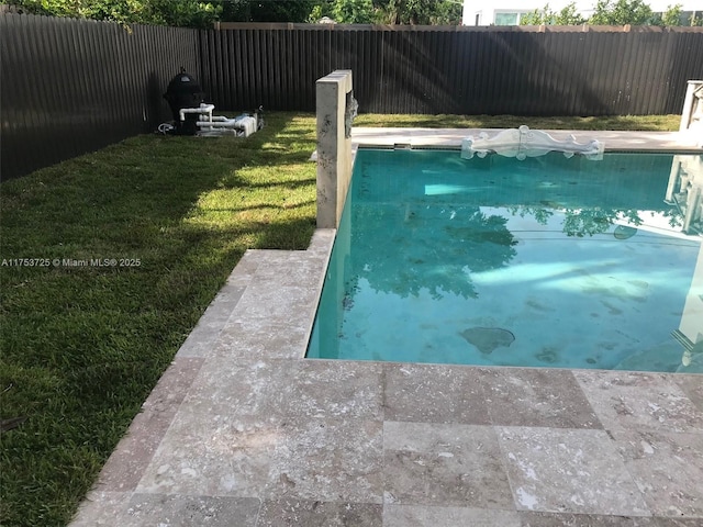 view of swimming pool with a fenced in pool, a fenced backyard, and a lawn