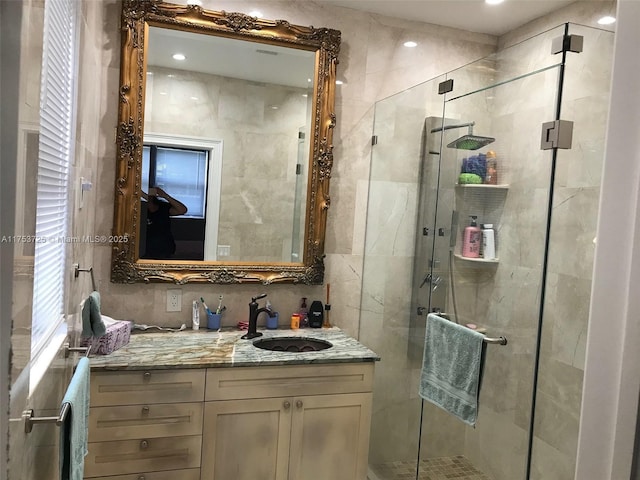 full bath with vanity and a shower stall