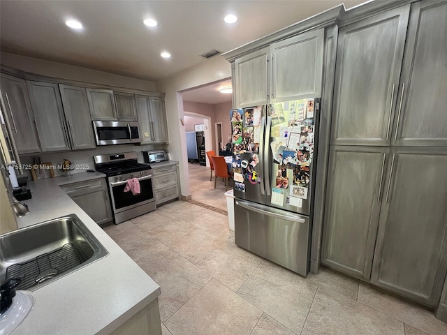 kitchen featuring recessed lighting, arched walkways, appliances with stainless steel finishes, a sink, and visible vents