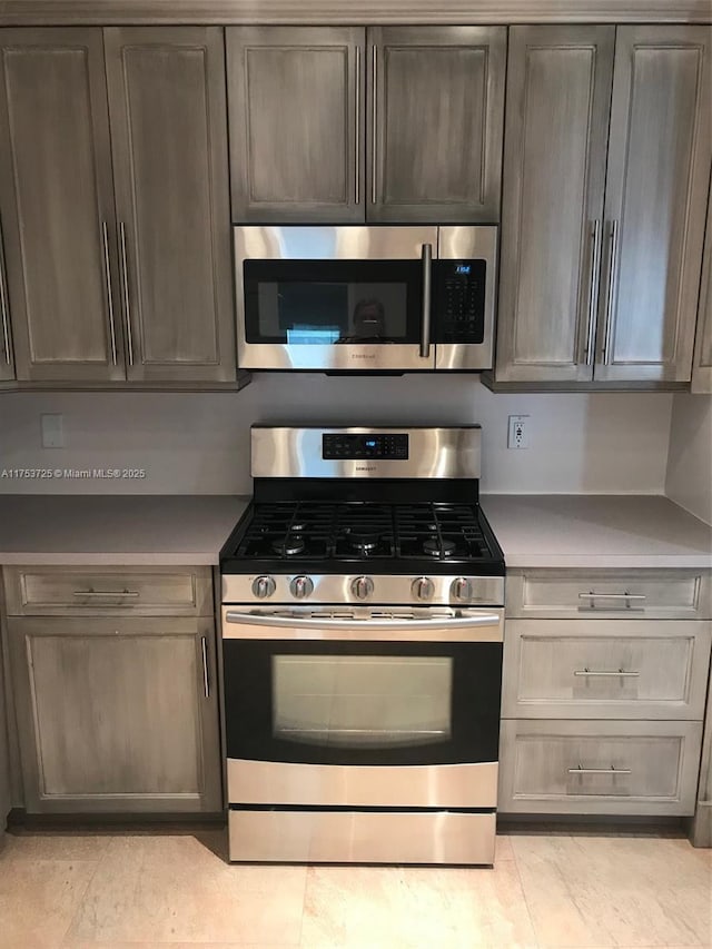 kitchen with stainless steel appliances and light countertops