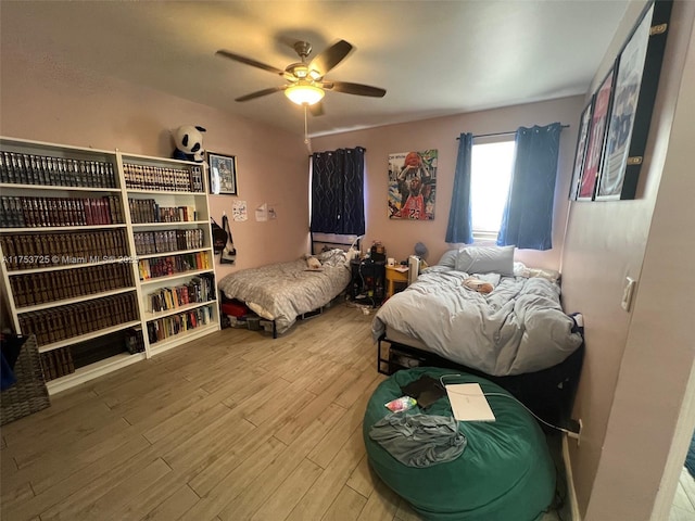 bedroom featuring wood finished floors and a ceiling fan