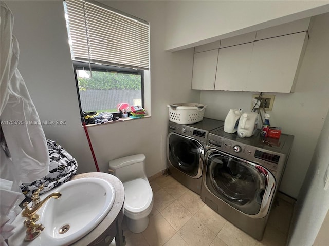 laundry room with washer and clothes dryer, laundry area, and a sink