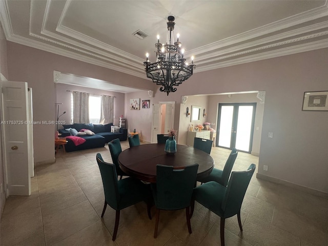 dining area featuring visible vents, a raised ceiling, a healthy amount of sunlight, and french doors