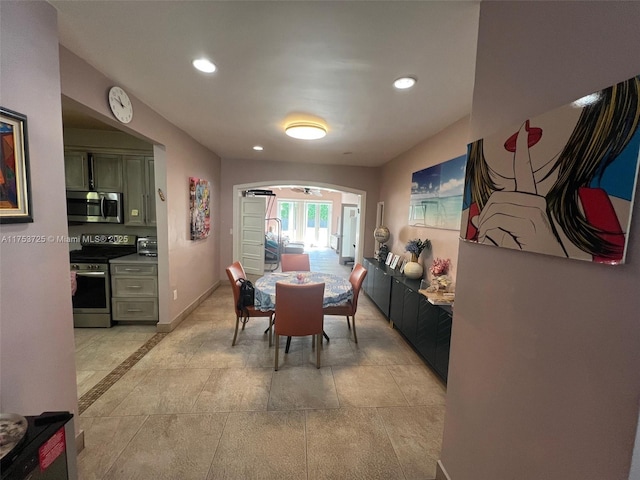 dining room featuring recessed lighting, baseboards, and arched walkways