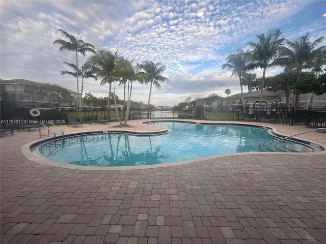 pool featuring fence and a patio