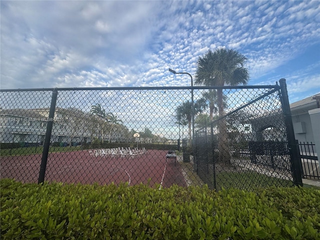 view of sport court featuring fence