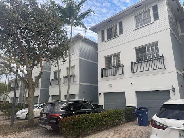 view of building exterior featuring a garage and decorative driveway