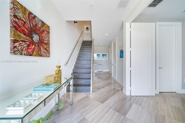 staircase featuring visible vents and recessed lighting