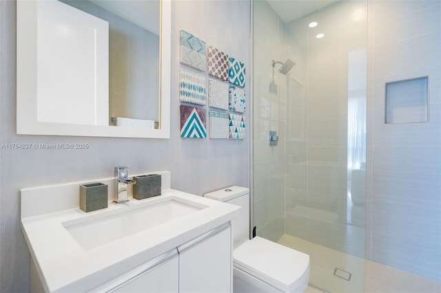 full bath featuring vanity, a shower stall, and toilet