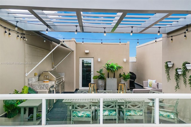 exterior space with grilling area, a pergola, and outdoor dining space