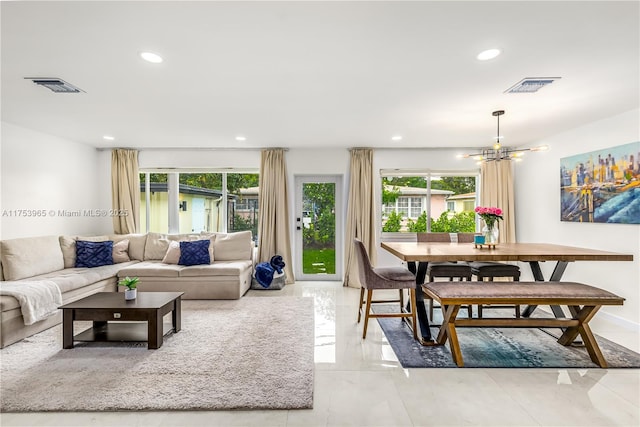 living area featuring a chandelier, recessed lighting, and visible vents