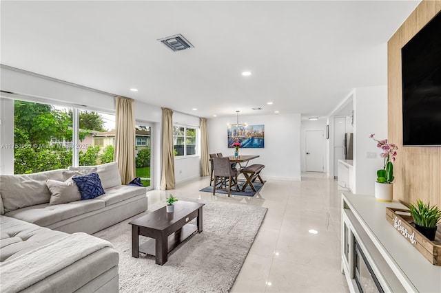 living room with visible vents, baseboards, light tile patterned floors, a chandelier, and recessed lighting