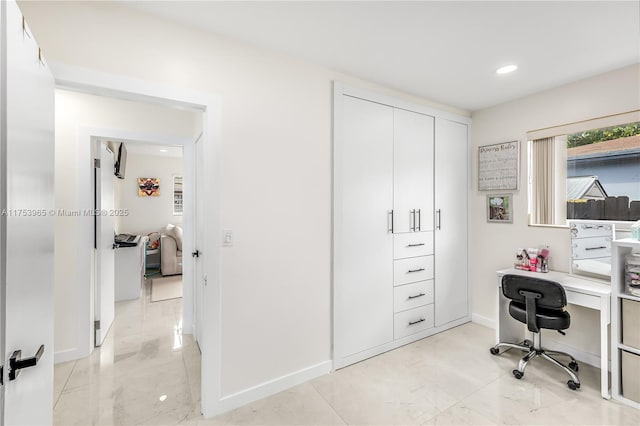 office space with recessed lighting, marble finish floor, and baseboards