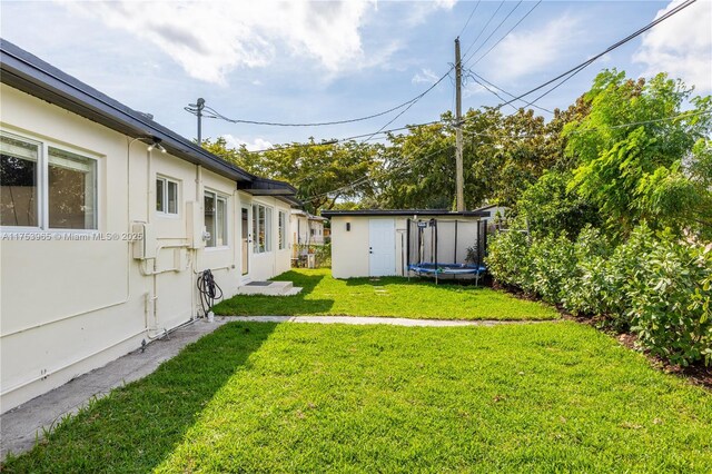 view of yard featuring an outbuilding and a storage unit