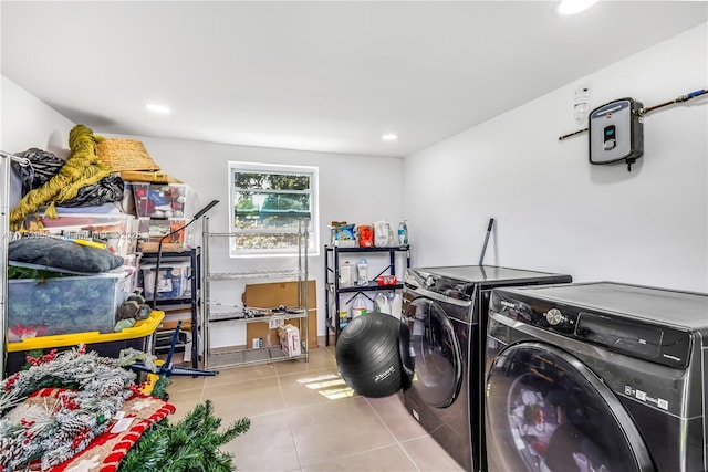 laundry area featuring tile patterned floors, recessed lighting, washing machine and dryer, and laundry area