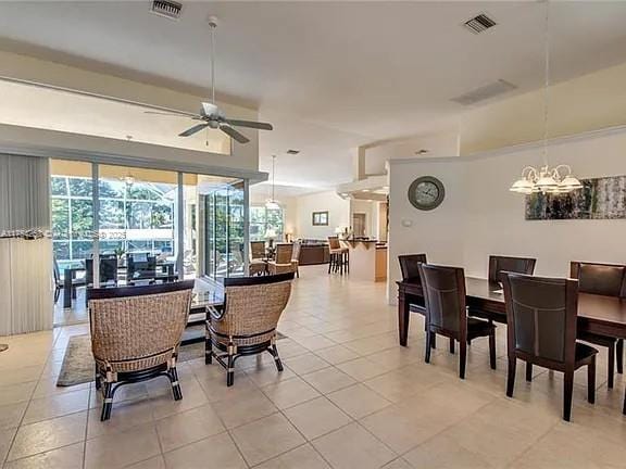 dining space with a ceiling fan, visible vents, and light tile patterned floors