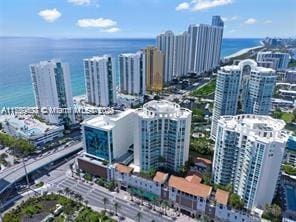 bird's eye view featuring a water view and a city view