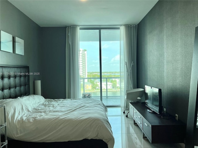 bedroom featuring access to exterior, expansive windows, and light tile patterned floors