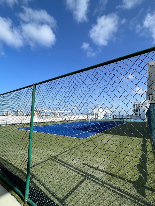 view of sport court featuring fence