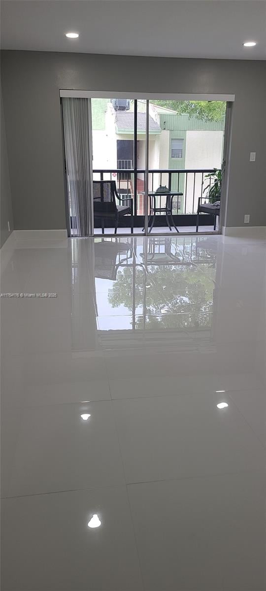 tiled spare room featuring recessed lighting and a healthy amount of sunlight