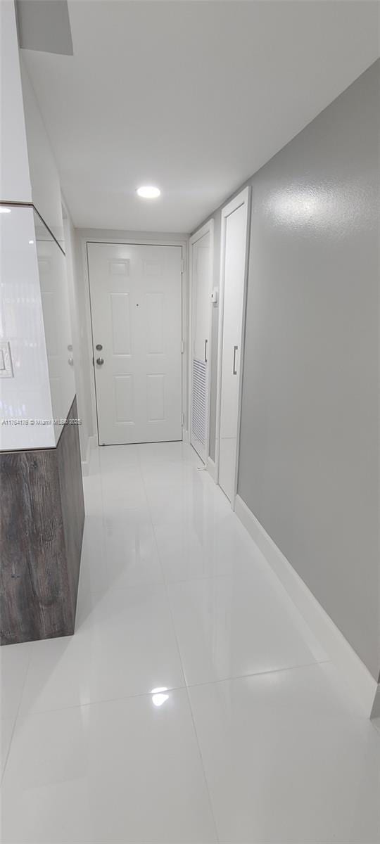 hallway with light tile patterned floors