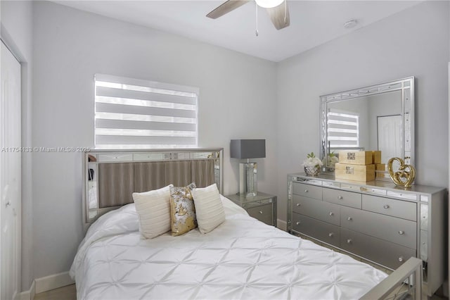 bedroom featuring ceiling fan and baseboards