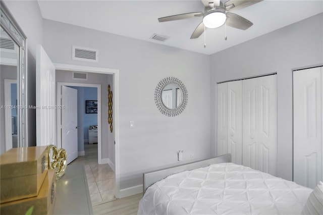 bedroom with a ceiling fan, visible vents, and baseboards