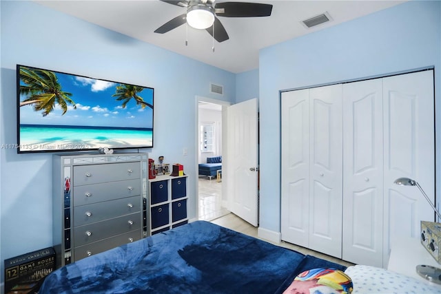 bedroom with a closet, visible vents, and a ceiling fan