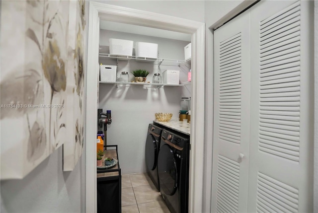 kitchen featuring washing machine and clothes dryer and light tile patterned floors