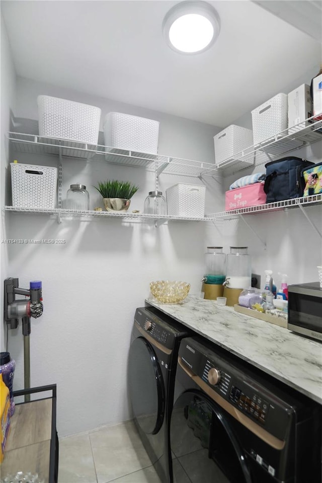 laundry room featuring laundry area, light tile patterned floors, and independent washer and dryer