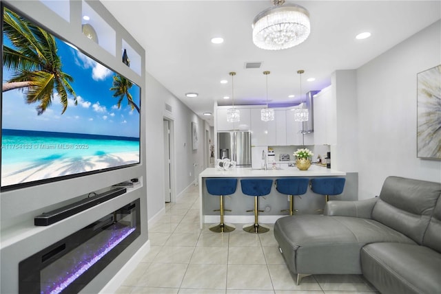 interior space with light tile patterned floors, baseboards, visible vents, an inviting chandelier, and recessed lighting