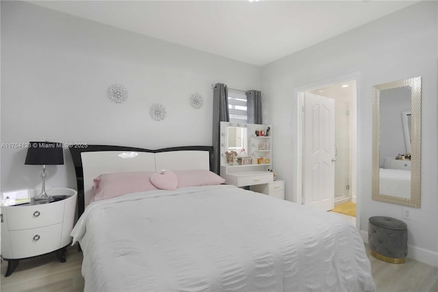 bedroom featuring wood finished floors and baseboards