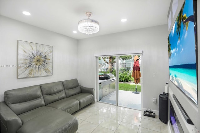 living area with light tile patterned floors, baseboards, a chandelier, and recessed lighting