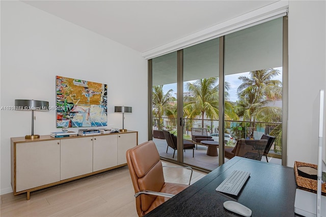 home office featuring light wood-style floors, french doors, and floor to ceiling windows